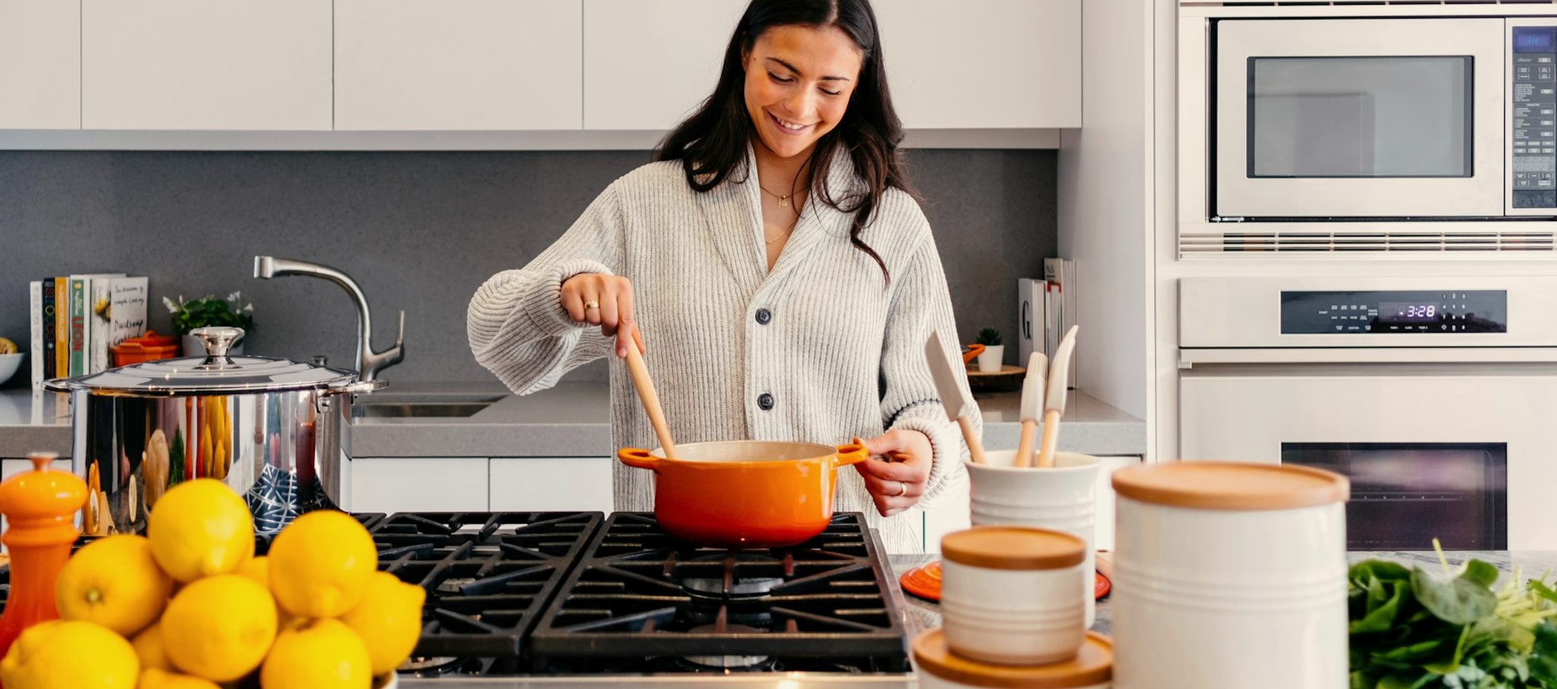 A woman cooking dinner at home in a warm kitchen